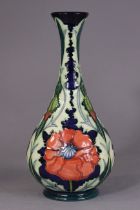 A modern Moorcroft pottery ovoid vase with tall narrow neck, decorated with a poppy design; 31cm