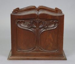 An early 20th century Art Nouveau carved mahogany magazine rack with floral decoration and moulded