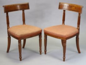A pair of George IV mahogany dining chairs with bow backs, reeded supports and padded seats