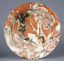 A 19th century English pottery large shallow bowl with all-over marbled glaze, raised on short foot,