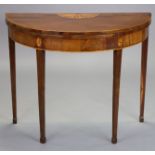 A late 18th century mahogany and satinwood crossbanded demi-lune card table with fold-over top,