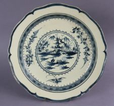 A Leeds-type creamware charger with shaped rim, painted in blue with a Chinese river landscape to