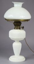 A Victorian opaline glass oil table lamp (converted to electricity) with moulded shell design &