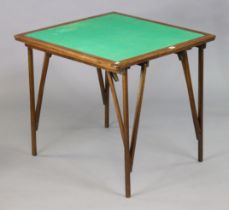 An Edwardian oak card table inset green baize to the rectangular top, & on four square fold-away