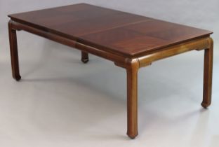 A Chinese-style extending dining table of traditional form having a rectangular top, two