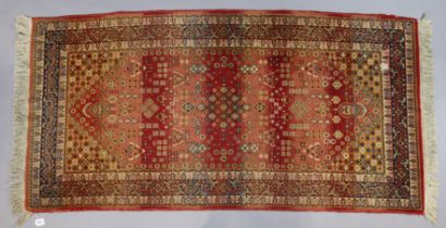 An Indian Caucasian design rug of crimson & ivory ground & having all-over repeating multi-