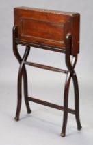 A 19th century mahogany campaign writing desk on folding trestle stand with x-shaped supports,