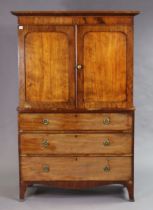 A 19th century mahogany small linen press fitted with three sliding trays, enclosed by a pair of