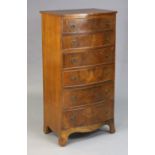 A mahogany tall bow-front chest fitted six long graduated drawers with iron ring handles, & on o-gee