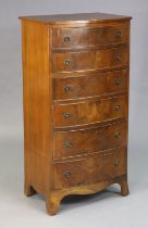 A mahogany tall bow-front chest fitted six long graduated drawers with iron ring handles, & on o-gee