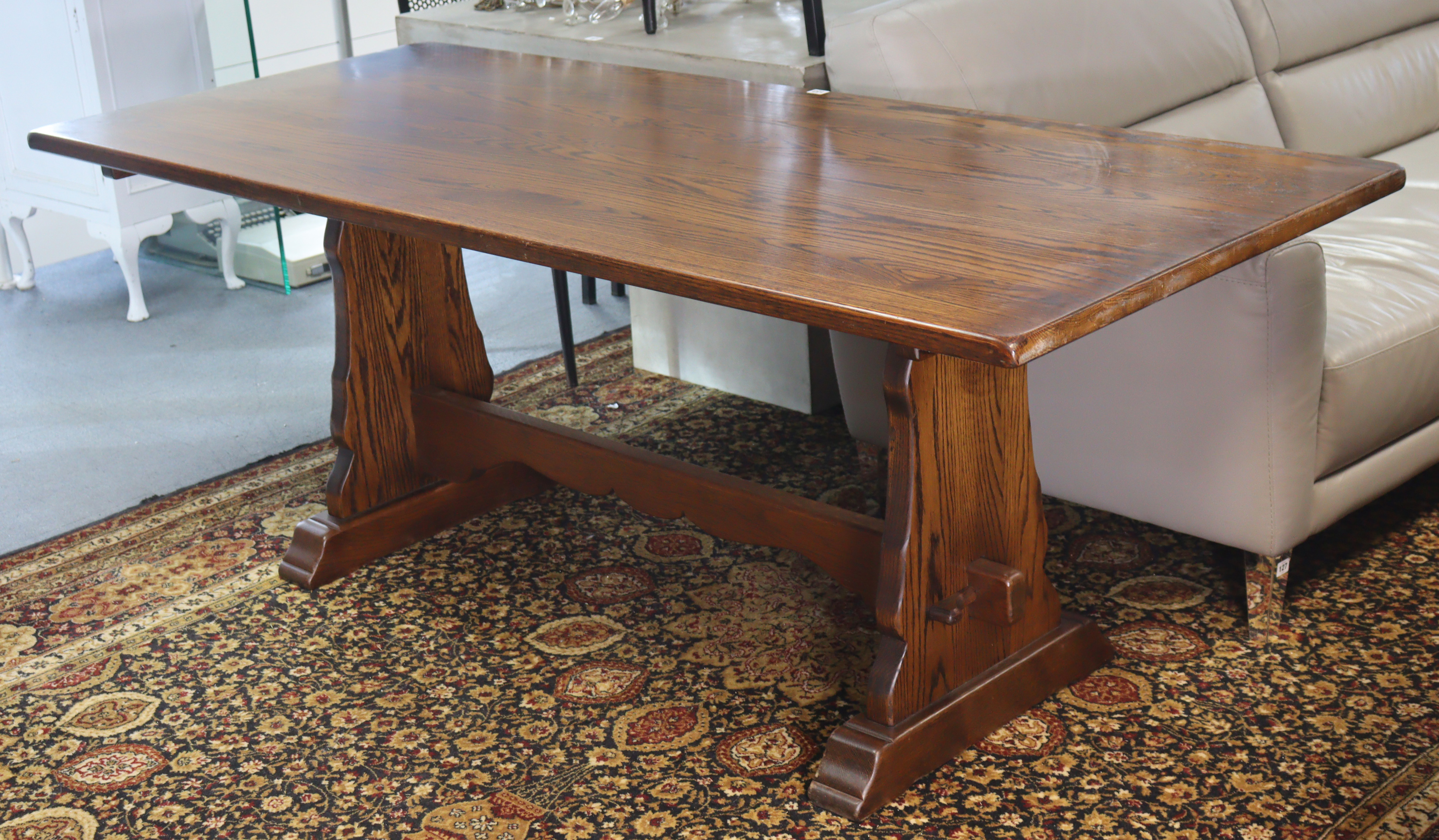 An oak refectory table with a rectangular top, & on shaped end supports joined by a shaped centre