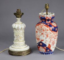 A late 19th century opaque glass table lamp with white-overlaid decoration, & an Imari vase table