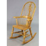 A Windsor-style splat-back rocking chair with a hard seat, & on turned supports with spindle