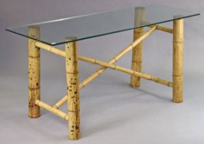 A bamboo dining table on four legs joined by x-shaped stretchers, & having a plate-glass rectangular