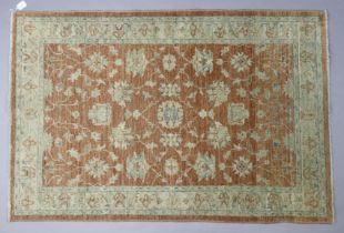 A Chobi rug of beige & ivory ground & having repeating multi-coloured floral design to centre within