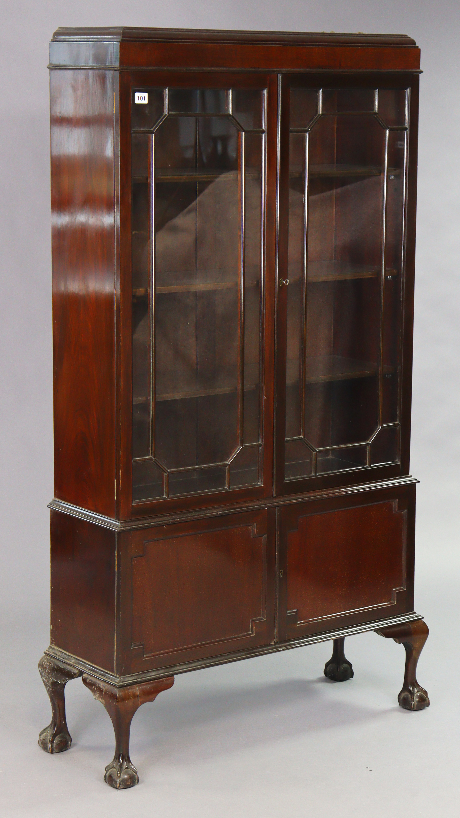 An Edwardian mahogany tall china display cabinet with three adjustable shelves enclosed by a pair of