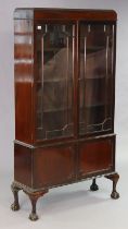 An Edwardian mahogany tall china display cabinet with three adjustable shelves enclosed by a pair of