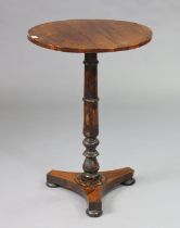 A 19th century rosewood occasional table with a circular top, & on a vase-turned centre column &
