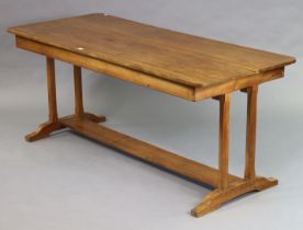 A mid-20th century Cotswold School walnut dining table by Charles Herbert (Bert) Uzzell, having