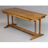 A mid-20th century Cotswold School walnut dining table by Charles Herbert (Bert) Uzzell, having