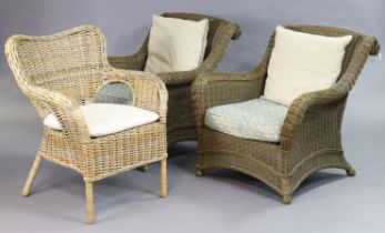 A pair of wicker conservatory armchairs, each with loose cushions to the seat & back; and another