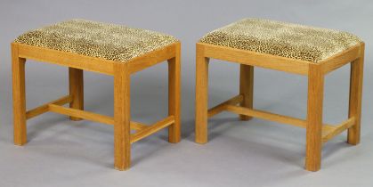 A pair of light oak dressing table stools each with a padded drop-in-seat upholstered leopard