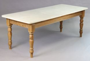 A pine farmhouse table with light grey painted rectangular top having rounded corners, the natural