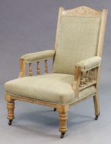 A Victorian carved oak frame armchair having a padded seat back & arms, upholstered cream