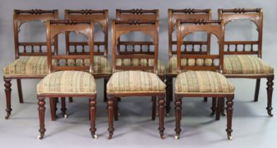 A set of eight Victorian mahogany dining chairs each with a spindle-rail to the open back, having