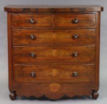 A 19th century mahogany bow-front chest fitted two short & three long graduated drawers with