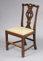 A 19th century oak dining chair with a carved & pierced splat-back, padded drop-in-seat, & on square