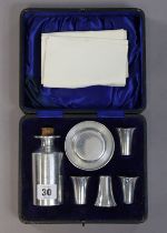 A stainless-steel seven-piece priest’s travelling communion set, with case.