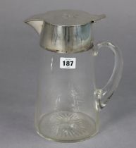 A glass carafe with French engraved armorial to the silver-plated hinged lid, 25cm high.