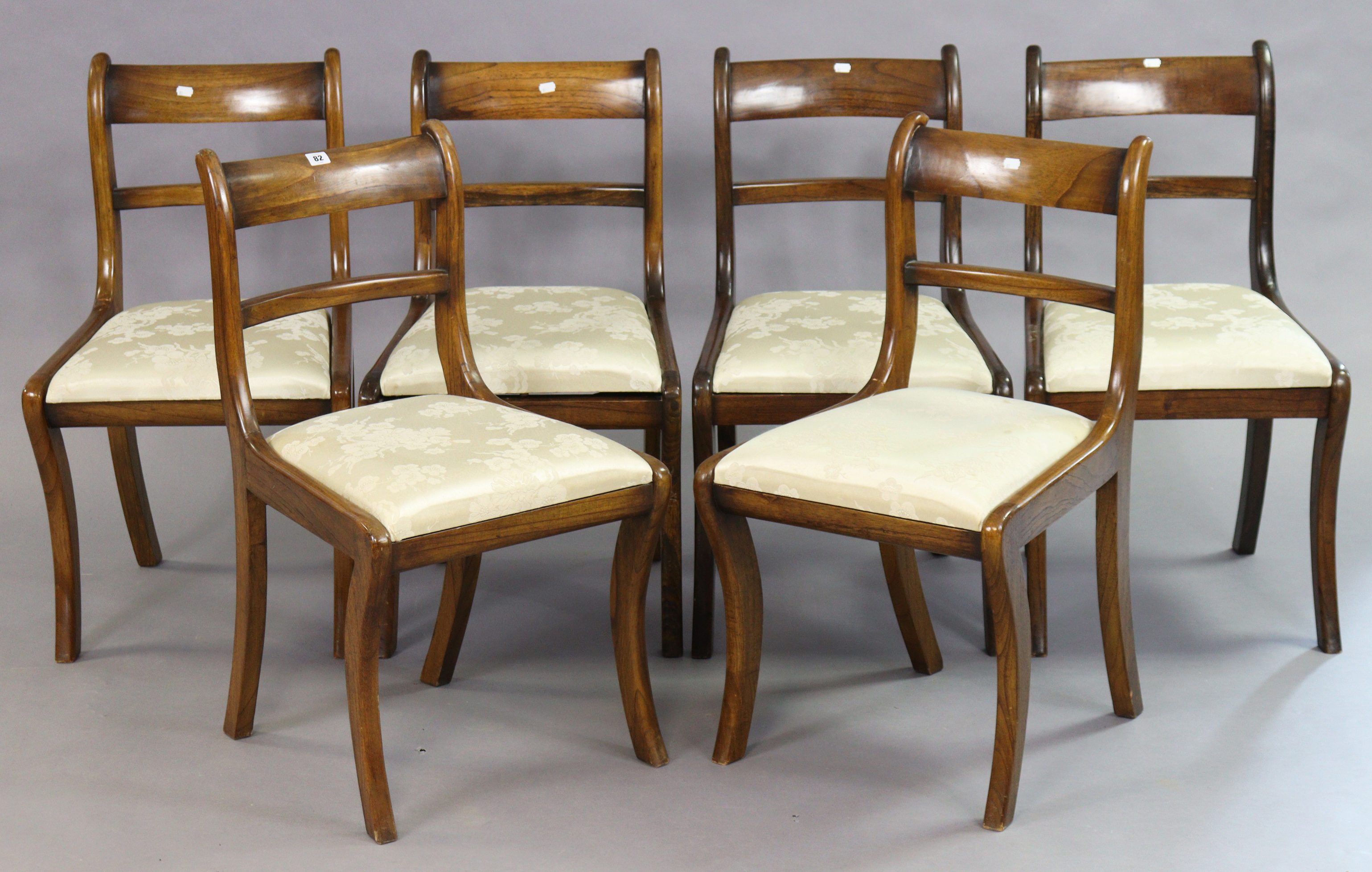 A set of six 19th century-style mahogany bow-back dining chairs each with a padded drop-in-seat, &