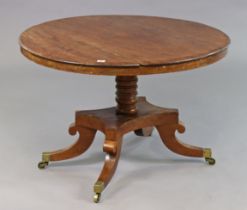 A 19th century mahogany loo table with a circular tilt-top, & on a vase-turned centre column &