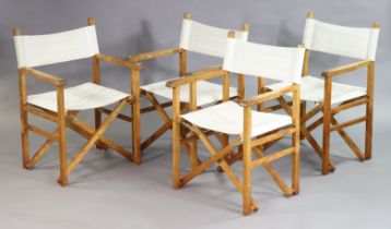 A set of four folding director’s chairs.