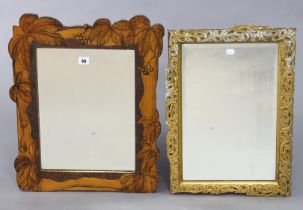 A rectangular wall mirror in a poker-work wooden frame inset with a bevelled plate, 58cm x 46cm; & a