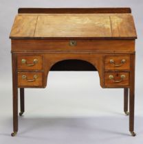 A Victorian mahogany clerks’ desk with a fitted interior enclosed by a sloping hinged lid, fitted