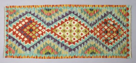 A Kilim small rug of multi-coloured geometric design, 157cm x 65cm.