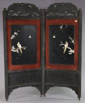 A Japanese black & red painted & carved wooden tall twin-folding draught screen (w.a.f.) 181cm high.