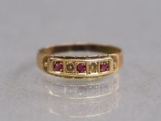 A 15ct. gold ring set row of three small rubies separated by two seed pearls; size: P; 1.7gm.
