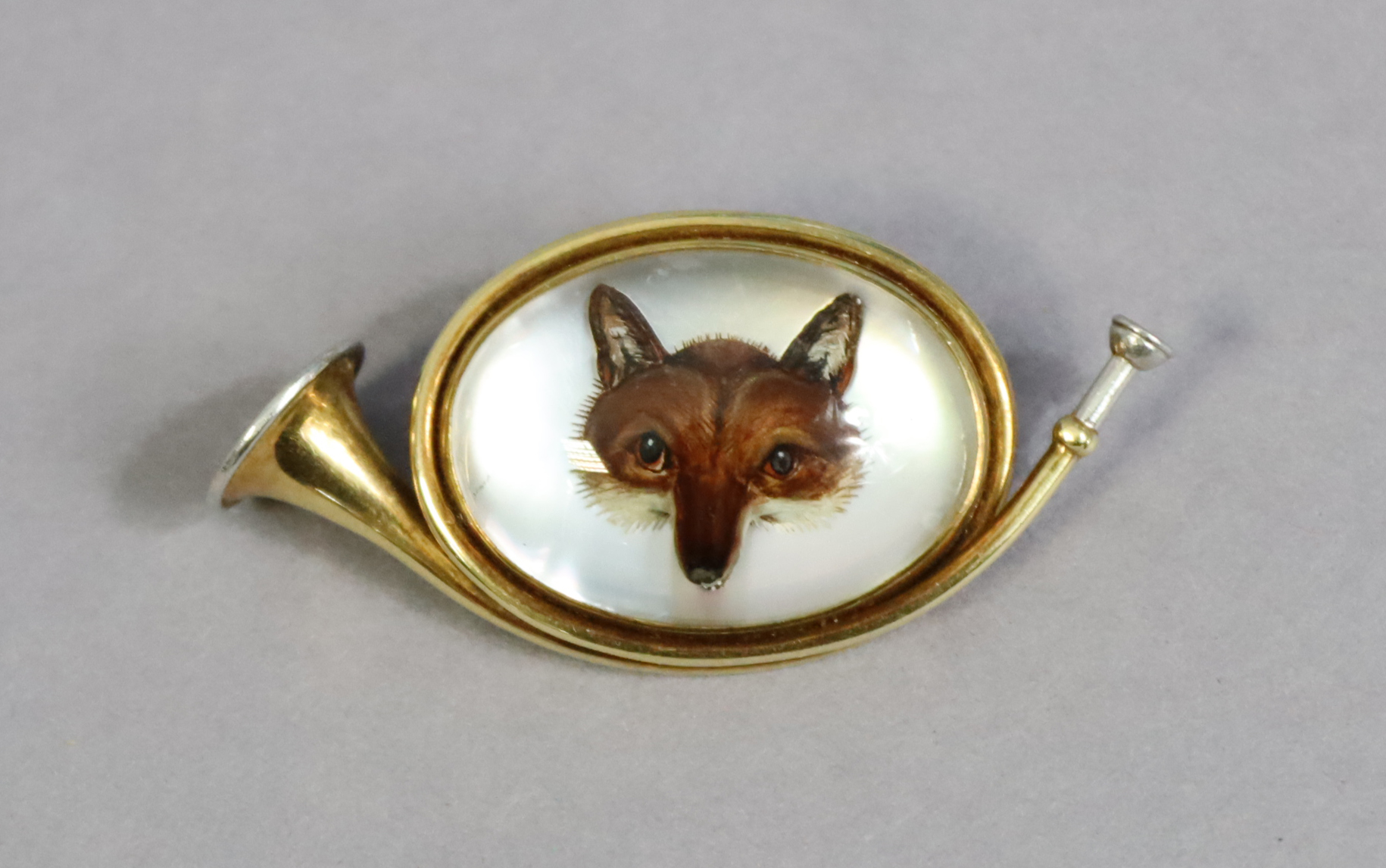 A Tiffany & Co yellow & white-metal novelty hunting horn brooch inset with Essex crystal fox