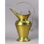 A late 19th century brass water jug designed by Christopher Dresser for Benham & Froud, with