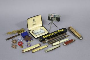 Two silver sporting medals; a brass sovereign scale; two cigarette lighters; three various pens; &