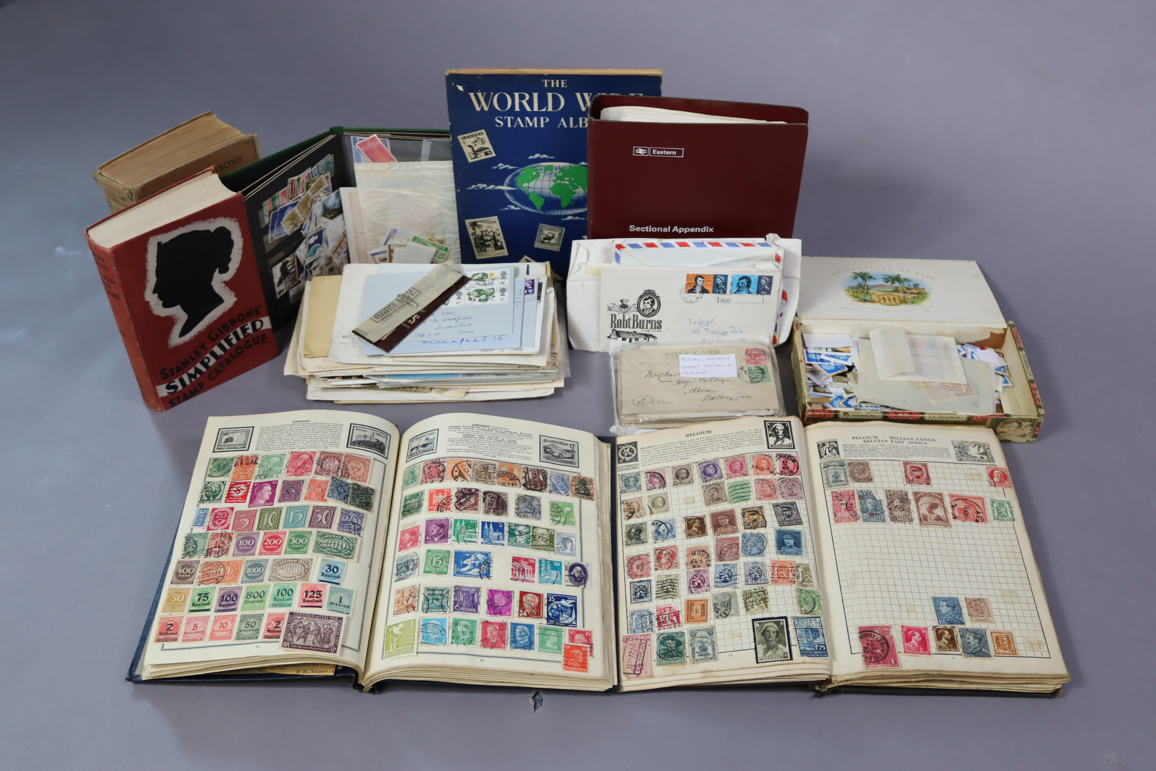 A collection of world stamps in three albums & a stock-book; a quantity of loose stamps; various
