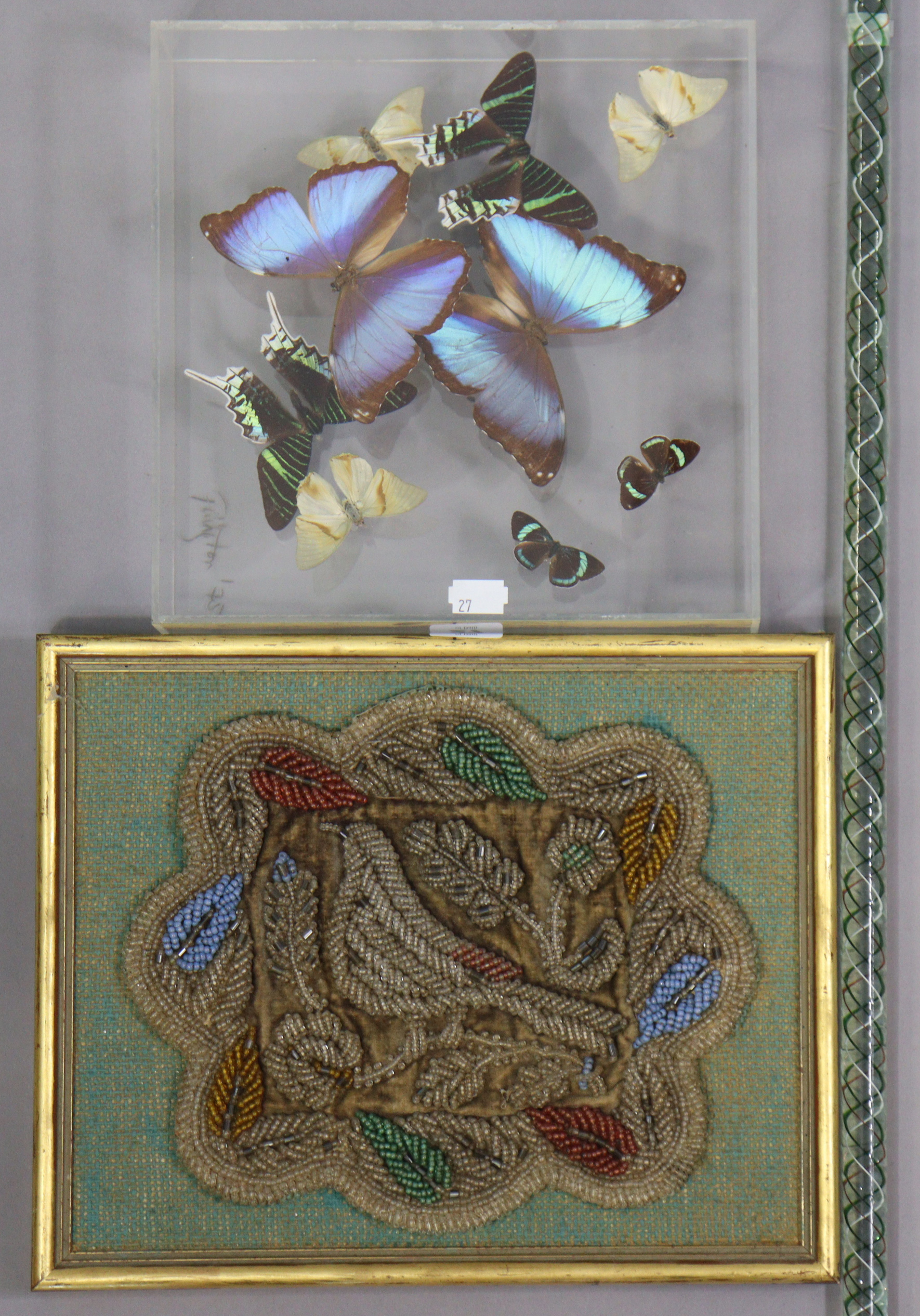 An early 20th century beadwork panel depicting a bird amongst flowers, 24cm & 30.5cm, in a gilt