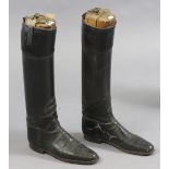 A pair of vintage black leather riding boots with treen trees.