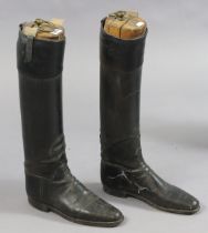 A pair of vintage black leather riding boots with treen trees.