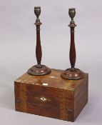 A pair of late 19th/early 20th century treen & bronzed metal candlesticks each with a baluster-