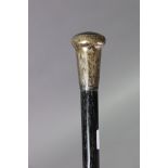 A George V ebony walking cane with an engraved silver knob handle, London 1925, 93cm high.